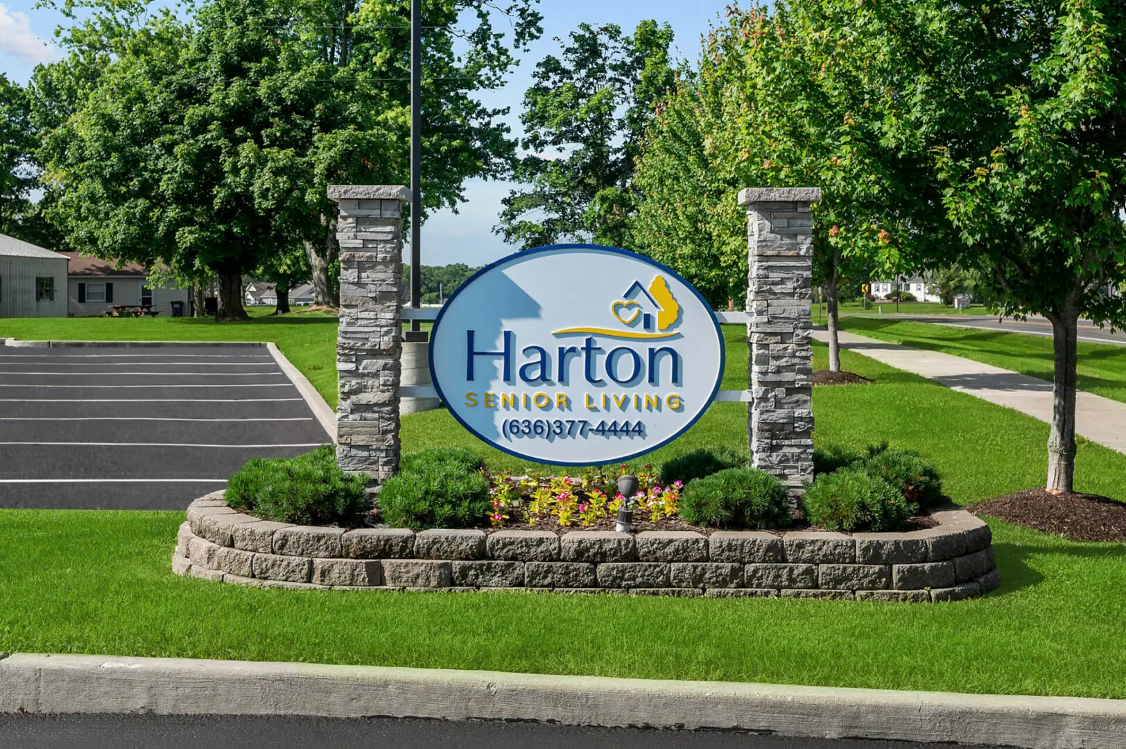 Harton Senior Living sign with landscaping.